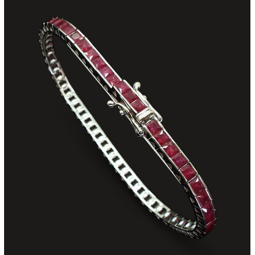 2746 - RUBY LINE BRACELETset with fifty seven square cut rubies in tension settings, the mount in 18ct whit... 