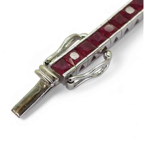 2746 - RUBY LINE BRACELETset with fifty seven square cut rubies in tension settings, the mount in 18ct whit... 