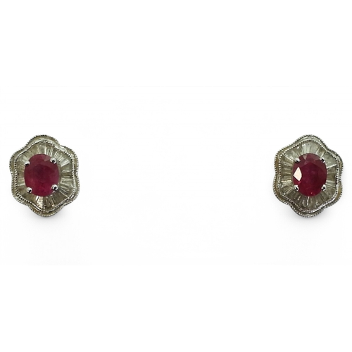 2754 - A RUBY & DIAMOND SUITEthe earrings set with oval cut rubies of approx 5mm x 4mm, surrounded with... 