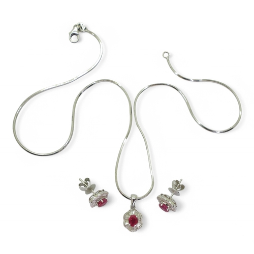 2754 - A RUBY & DIAMOND SUITEthe earrings set with oval cut rubies of approx 5mm x 4mm, surrounded with... 