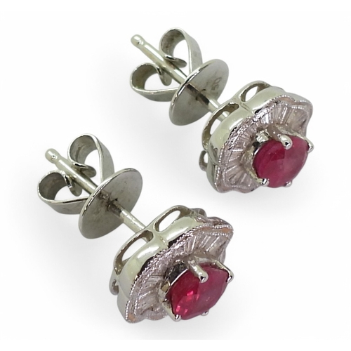 2754 - A RUBY & DIAMOND SUITEthe earrings set with oval cut rubies of approx 5mm x 4mm, surrounded with... 