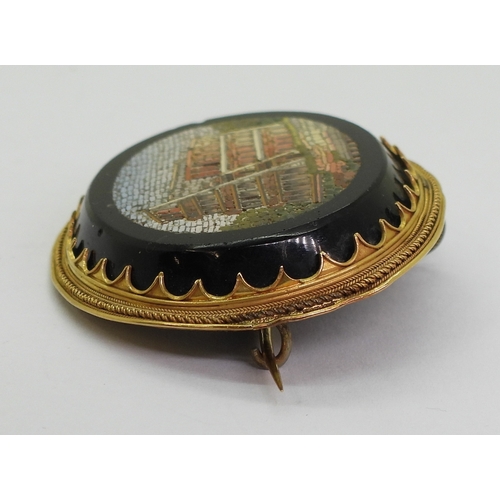 2719 - A MICRO MOSAIC BROOCHdepicting the Colosseum, in a yellow metal brooch mount, the pin is stamped wit... 