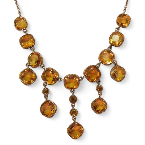 2766 - A VINTAGE CITRINE NECKLACEon a fine yellow metal trace chain, each citrine is cushion cut and gently... 