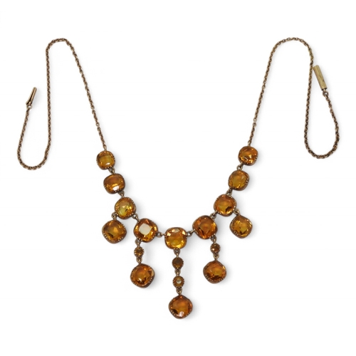 2766 - A VINTAGE CITRINE NECKLACEon a fine yellow metal trace chain, each citrine is cushion cut and gently... 