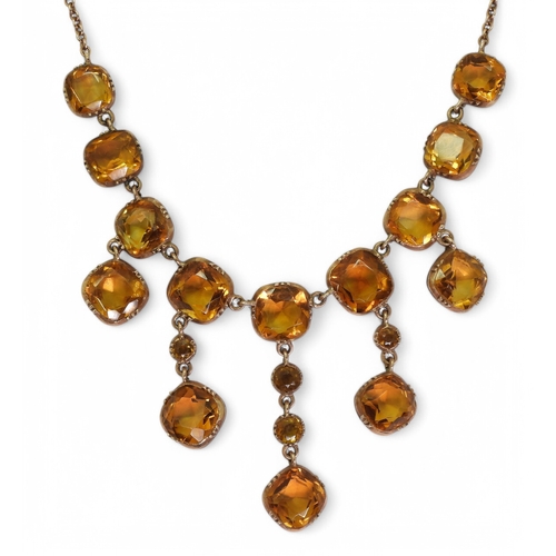 2766 - A VINTAGE CITRINE NECKLACEon a fine yellow metal trace chain, each citrine is cushion cut and gently... 