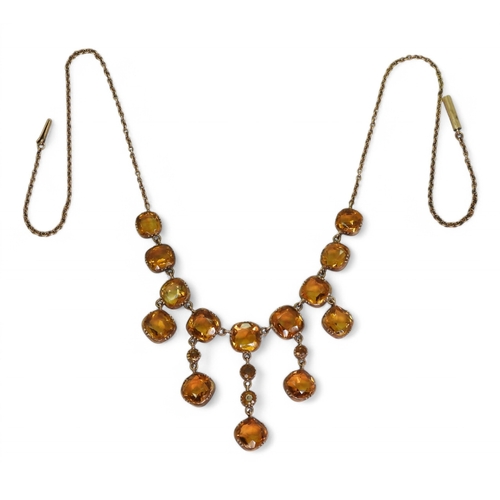 2766 - A VINTAGE CITRINE NECKLACEon a fine yellow metal trace chain, each citrine is cushion cut and gently... 