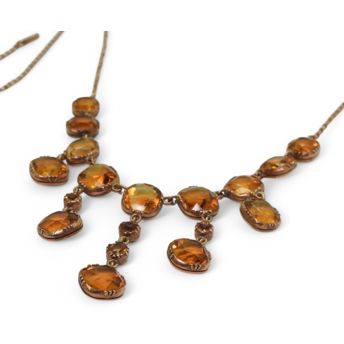 2766 - A VINTAGE CITRINE NECKLACEon a fine yellow metal trace chain, each citrine is cushion cut and gently... 