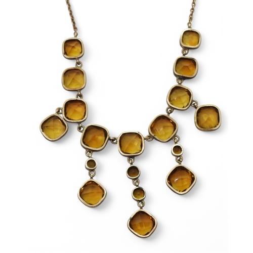 2766 - A VINTAGE CITRINE NECKLACEon a fine yellow metal trace chain, each citrine is cushion cut and gently... 