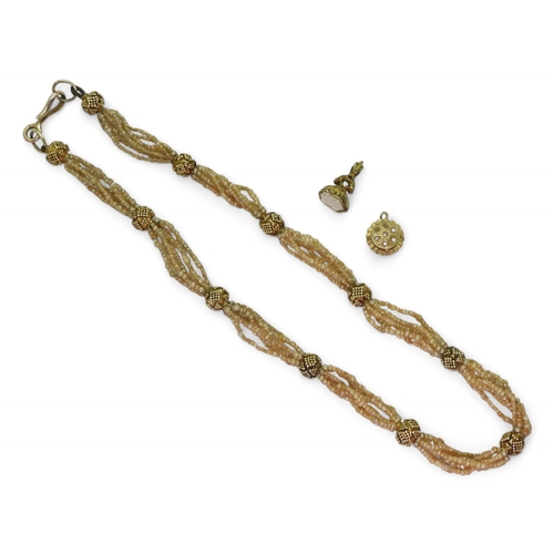 2770 - VINTAGE JEWELSa multi string of seed pearls with granulation decorated yellow metal accent beads, an... 