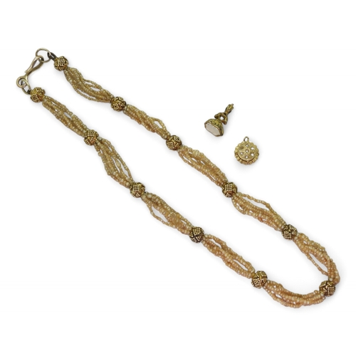 2770 - VINTAGE JEWELSa multi string of seed pearls with granulation decorated yellow metal accent beads, an... 