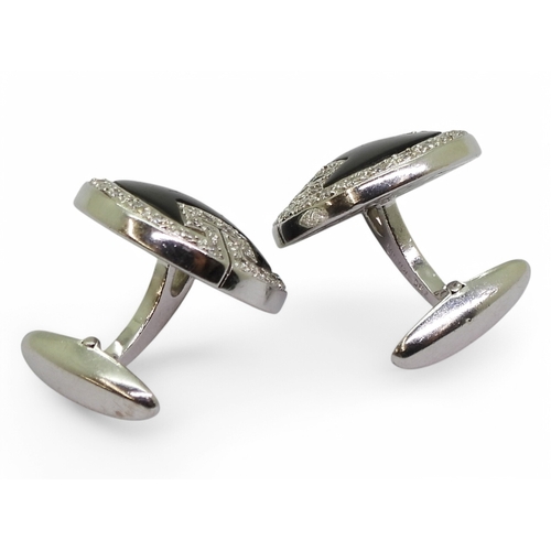 2771 - ONYX & DIAMOND CUFFLINKSmade in 18ct white gold with a key pattern picked out in pave set diamon... 