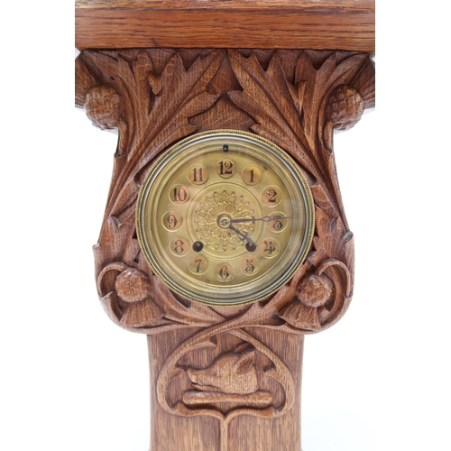 2160 - AN ARTS AND CRAFTS OAK CLOCKcarved with entwining thistles and the Campbell arms of a boars head on ... 