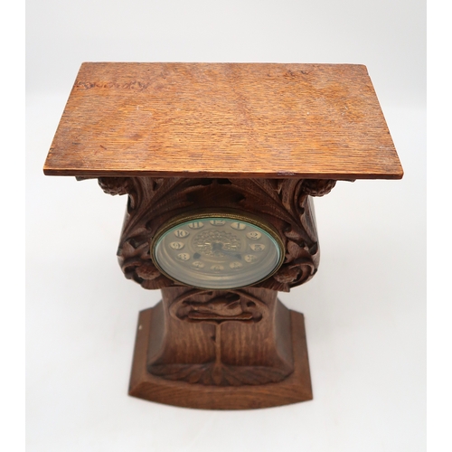 2160 - AN ARTS AND CRAFTS OAK CLOCKcarved with entwining thistles and the Campbell arms of a boars head on ... 