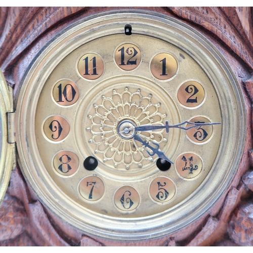 2160 - AN ARTS AND CRAFTS OAK CLOCKcarved with entwining thistles and the Campbell arms of a boars head on ... 