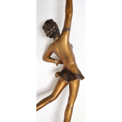 2168 - AN ART DECO SPELTER LADY LAMPmodelled wearing a short dress with one arm raised, the other on her hi... 