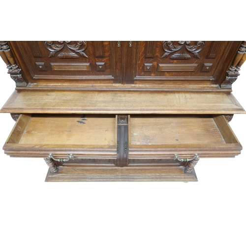 2028 - A 19TH CENTURY CARVED OAK CONTINENTAL COURT CABINET with carved moulded cornice over pair of ca... 