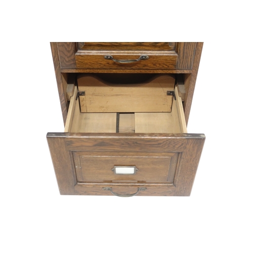 2041 - AN EARLY 20TH CENTURY OAK FILING CABINETwith pair of index card drawers over three filing drawers on... 