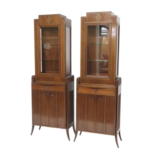 2043 - A PAIR OF EARLY 20TH CENTURY ART MAHOGANY AND FRUITWOOD INLAID DISPLAY CABINETSwith stepped tops ove... 