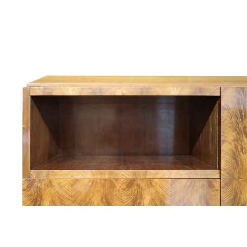 2049 - AN ART DECO FERNAND & GASTON SADDIER FLAME WALNUT VENEERED BOOKCASEwith chamfered top over pair ... 