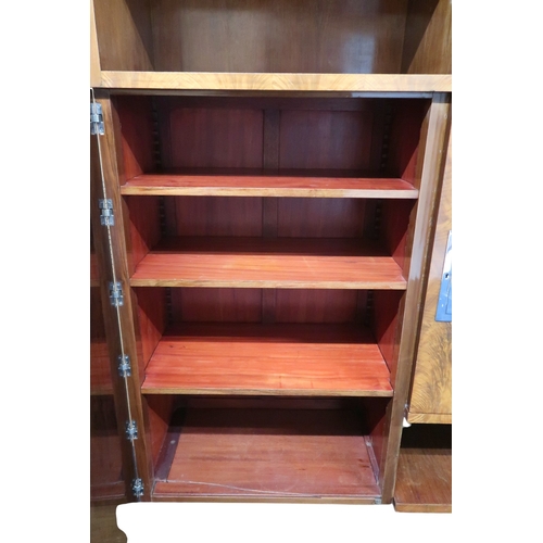 2049 - AN ART DECO FERNAND & GASTON SADDIER FLAME WALNUT VENEERED BOOKCASEwith chamfered top over pair ... 