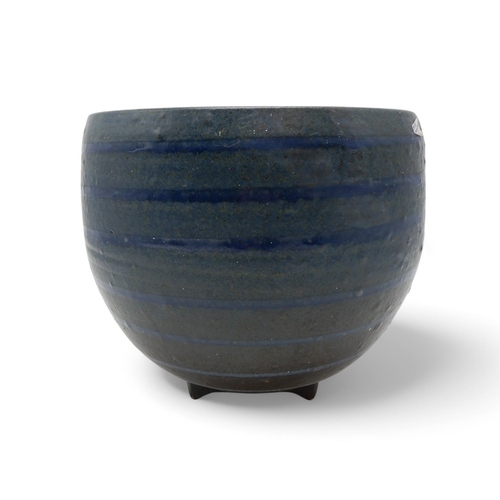 2229 - DAVID LLOYD JONES (1928-1994)A LARGE STUDIO POTTERY BOWLglazed in blue with ribbed detail, upon thre... 