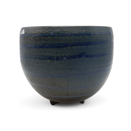 2229 - DAVID LLOYD JONES (1928-1994)A LARGE STUDIO POTTERY BOWLglazed in blue with ribbed detail, upon thre... 