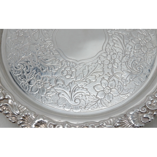 2368 - AN EDWARDIAN SILVER WATERby Cornelius Joshua Vander, London 1902, of circular form, with a cast scro... 