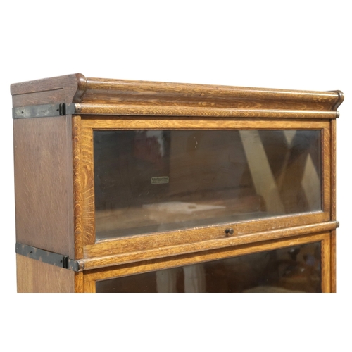 2051 - AN EARLY 20TH CENTURY OAK GLOBE WERNICKE SECTIONAL BOOKCASE with four glazed fall front section... 