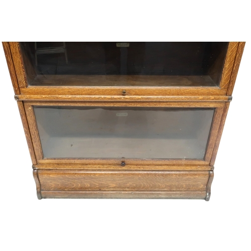 2051 - AN EARLY 20TH CENTURY OAK GLOBE WERNICKE SECTIONAL BOOKCASE with four glazed fall front section... 