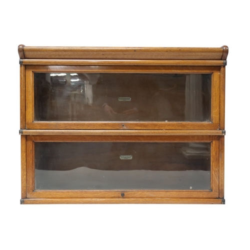 2051 - AN EARLY 20TH CENTURY OAK GLOBE WERNICKE SECTIONAL BOOKCASE with four glazed fall front section... 