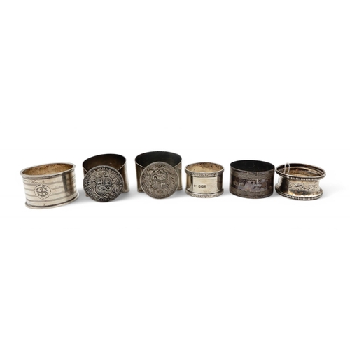 358 - Two white metal napkin rings set with 9 Decimos, together with four silver napkin rings, 95gms (6)