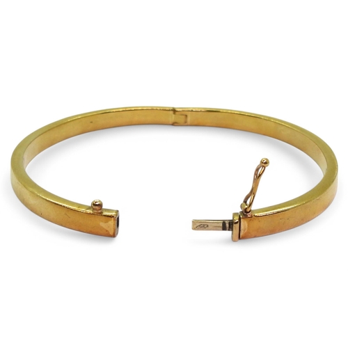 715 - A 9ct gold square section bangle, made from thick gauge gold with a box clasp and safety clip. Inner... 