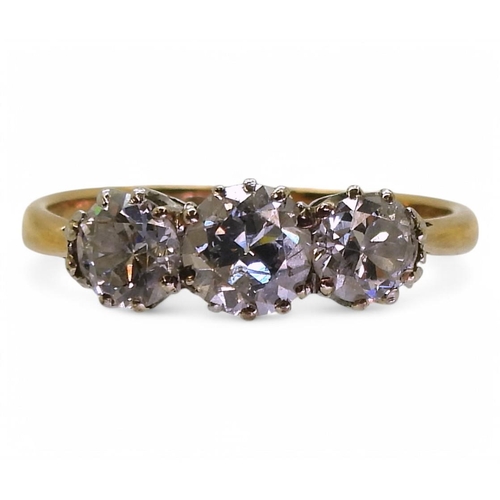 737 - A yellow metal and platinum, three stone diamond ring set with estimated 1.15cts of old cut diamonds... 