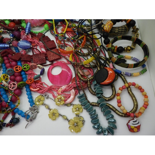 854 - A brightly coloured collection of costume jewellery to include tribal items, statement necklaces and... 