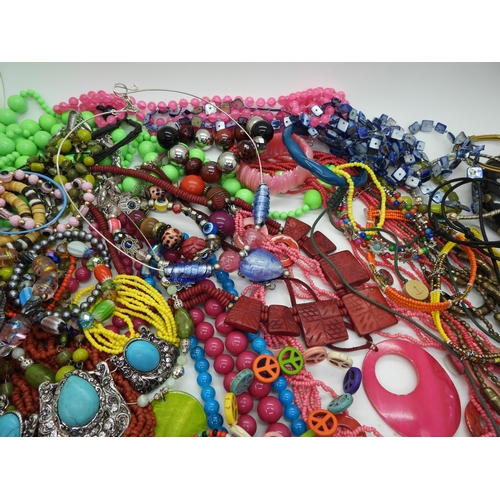 854 - A brightly coloured collection of costume jewellery to include tribal items, statement necklaces and... 