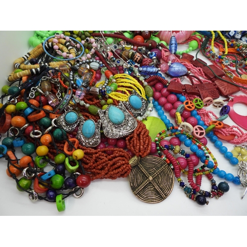 854 - A brightly coloured collection of costume jewellery to include tribal items, statement necklaces and... 