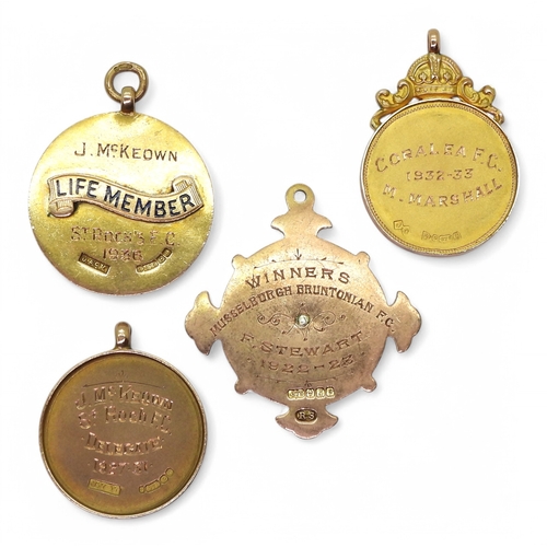 2552 - FOUR 9ct GOLD FOOTBALL MEDALSComprising a Paisley & District League Cup medal by Joseph Cutler, ... 