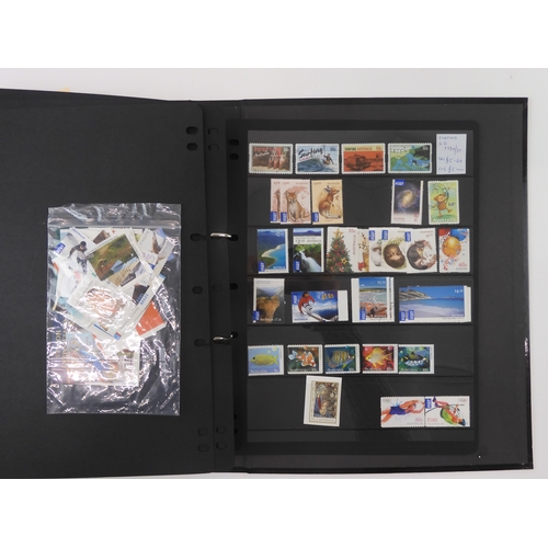 7021 - AUSTRALIA A collection of new and used stamps in three albums and a stock book to include booklets a... 