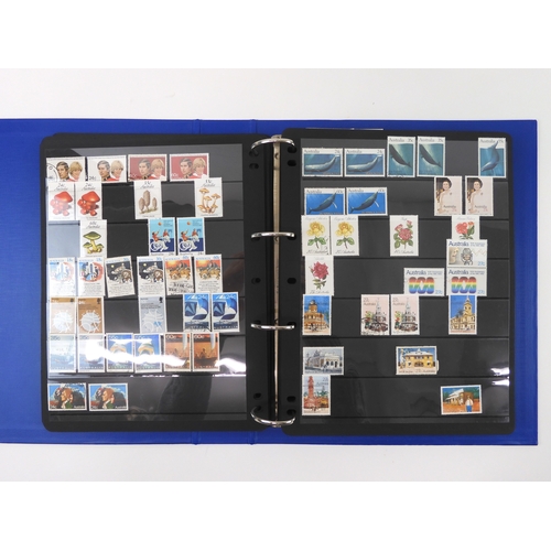 7021 - AUSTRALIA <br />A collection of new and used stamps in three albums and a stock book to include book...