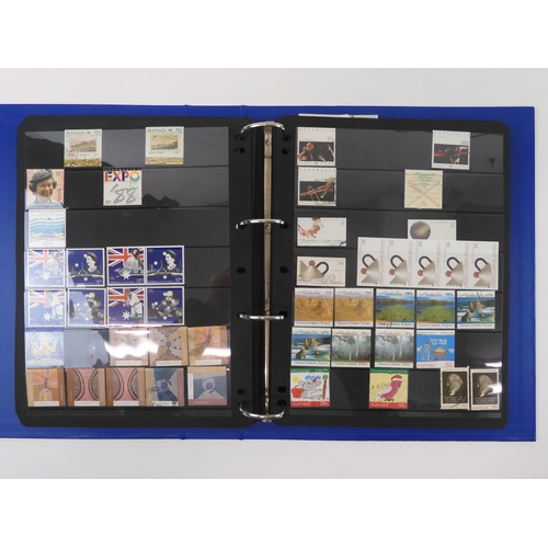 7021 - AUSTRALIA <br />A collection of new and used stamps in three albums and a stock book to include book...