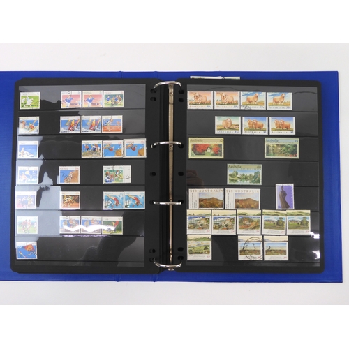 7021 - AUSTRALIA A collection of new and used stamps in three albums and a stock book to include booklets a... 