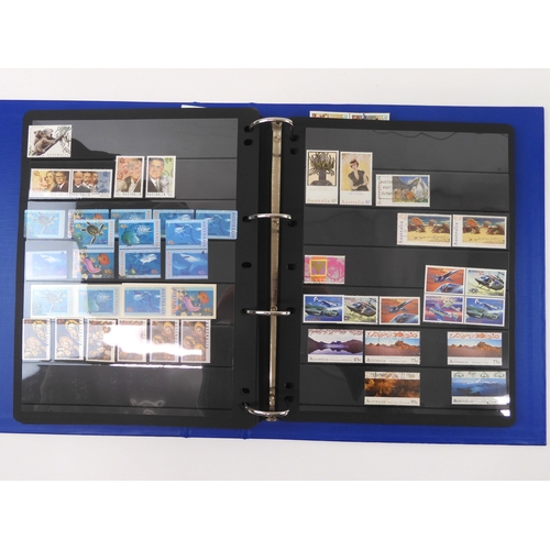 7021 - AUSTRALIA A collection of new and used stamps in three albums and a stock book to include booklets a... 