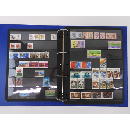 7021 - AUSTRALIA A collection of new and used stamps in three albums and a stock book to include booklets a... 