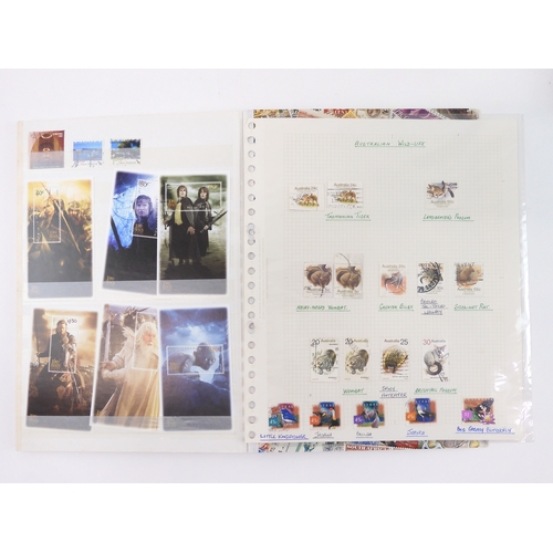 7021 - AUSTRALIA <br />A collection of new and used stamps in three albums and a stock book to include book...