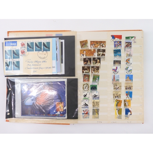 7021 - AUSTRALIA <br />A collection of new and used stamps in three albums and a stock book to include book...