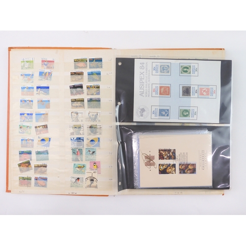 7021 - AUSTRALIA <br />A collection of new and used stamps in three albums and a stock book to include book...