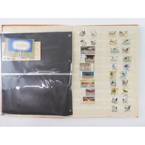 7021 - AUSTRALIA A collection of new and used stamps in three albums and a stock book to include booklets a... 