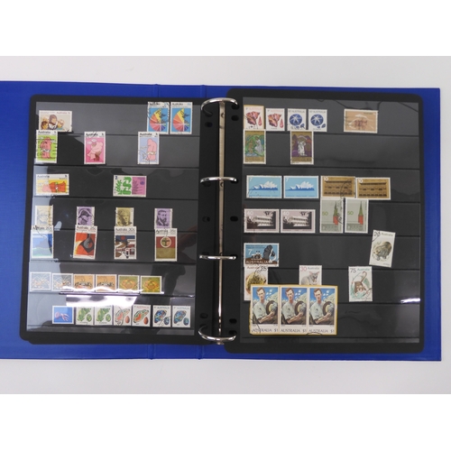 7021 - AUSTRALIA A collection of new and used stamps in three albums and a stock book to include booklets a... 