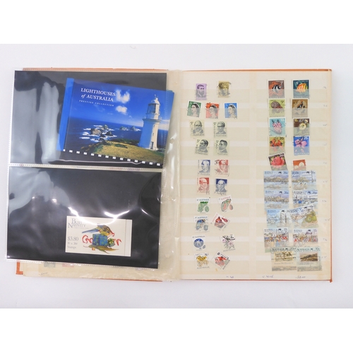 7021 - AUSTRALIA A collection of new and used stamps in three albums and a stock book to include booklets a... 