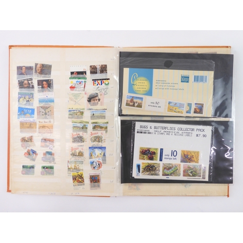 7021 - AUSTRALIA <br />A collection of new and used stamps in three albums and a stock book to include book...